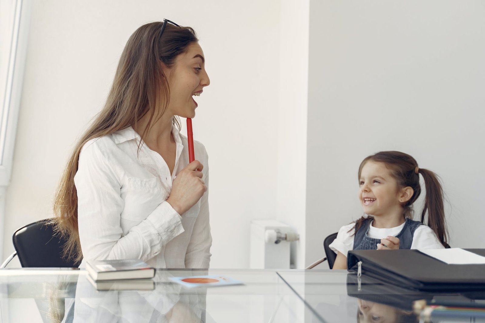 cheerful woman and kid having fun in office