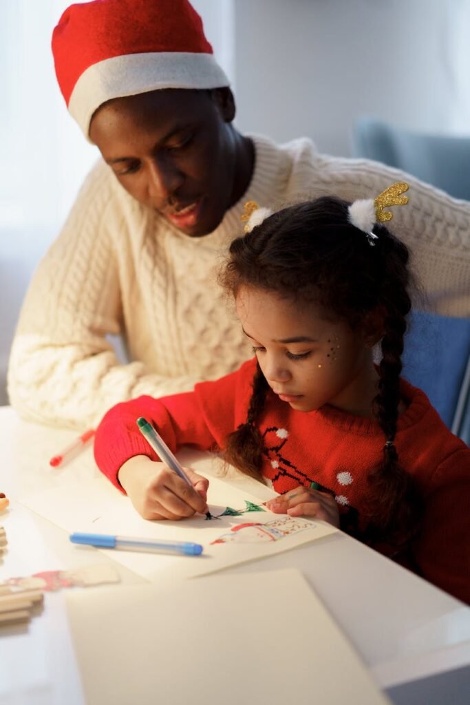 dad watching her daughter make a christmas letter